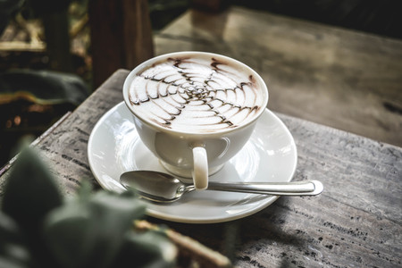 hot coffee latte in coffee shop.selective focus and hipster toneの写真素材