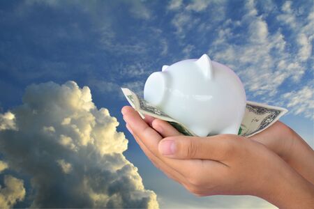 Hand holding dollar banknote and piggy bank . Soft focusの写真素材