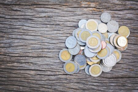 coin on old wood background a color vintage toneの写真素材