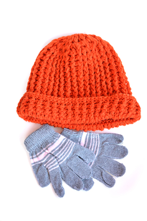 Red winter hat and glove on white backgroundの写真素材