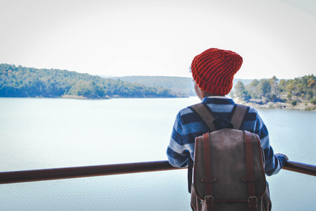 Happy Asian boy backpack in nature background, Relax time on holiday concept travel, color of vintage tone and soft focusの写真素材