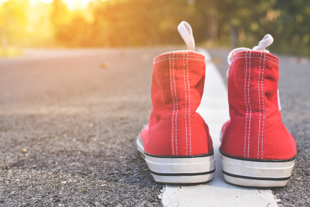 Red sneakers on road background .hipster tone and selective focusの写真素材