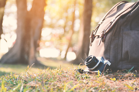 Bag and camera in nature color of vintage tone concept travelの写真素材