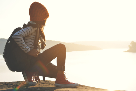 Happy Asian girl backpack in nature background, Relax time on holiday concept travel , color of vintage tone and soft focusの写真素材