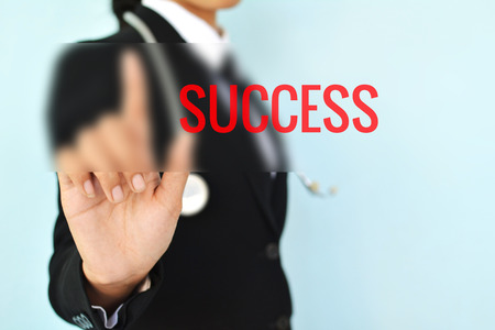 Portrait of Businesswomen with success word on blue background selective and soft focusの写真素材