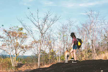 Happy Asian hipster women backpack in nature background, Relax time on holiday concept travel , color of vintage tone and soft focusの写真素材
