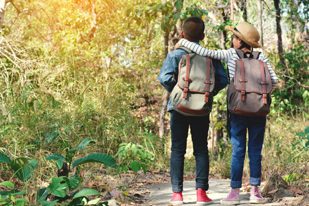 Happy Asian children backpack in nature background, Relax time on holiday concept travel , color of vintage tone and soft focusの写真素材