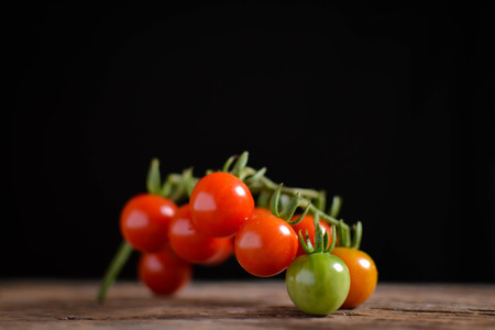 Still life group of tomato on old wood and black background, soft focusの写真素材