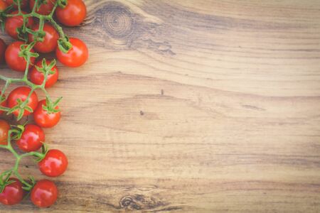 Hipster tone Top view group of tomato on old wood background, selective and soft focusの写真素材