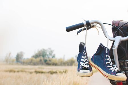 Jeans sneakers and bag on  bicycle ,Concept journey,hipster toneの写真素材