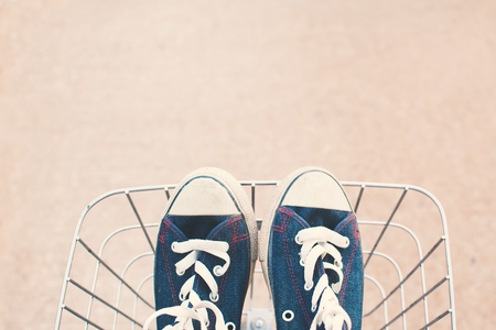 Jeans sneakers in basket ,hipster toneの写真素材