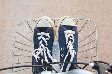 Jeans sneakers in basket ,hipster toneの写真素材