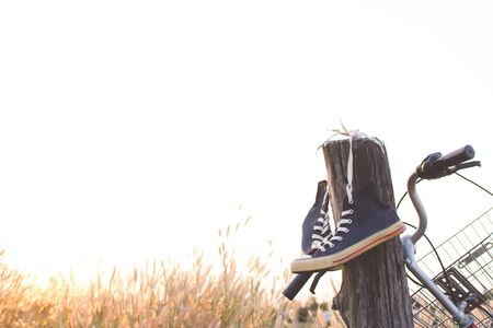 Jeans sneakers on bicycle ,Concept journey,hipster tone