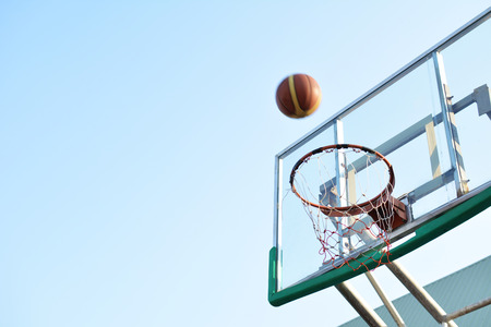Close up basketball on hoop in the  arenaの写真素材
