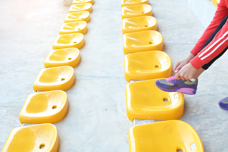 Young women shoe laces after exercise in staduimの写真素材