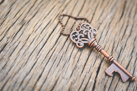 Old key on wood background with copy space a color of vintage tone selective and soft focusの写真素材