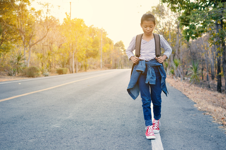 Happy Asian girl backpack  in nature background, Relax time on holiday concept travel ,color of vintage tone and soft focusの写真素材