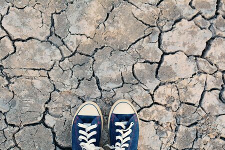 sneaker on crack dry ground, concept droughtの写真素材