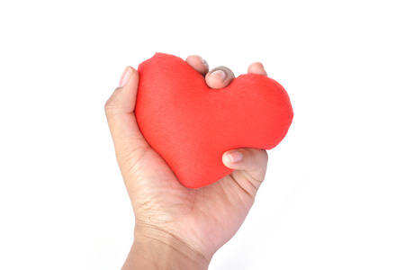 Hand holding red heart shape on white backgroundの写真素材