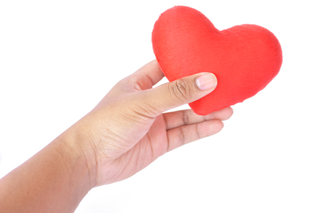 Hand holding red heart shape on white backgroundの写真素材