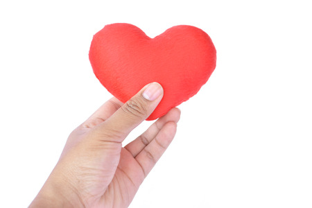Hand holding red heart shape on white backgroundの写真素材
