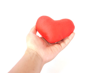 Hand holding red heart shape on white backgroundの写真素材