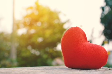 Red heart shape on old wood and bokeh backgroundの写真素材