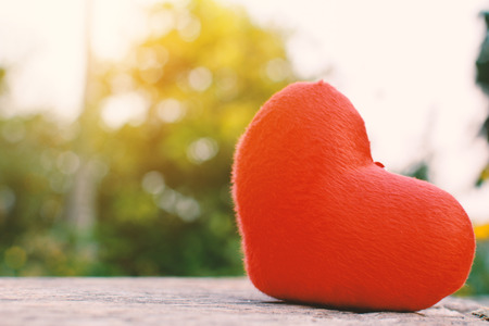 Red heart shape on old wood and bokeh backgroundの写真素材