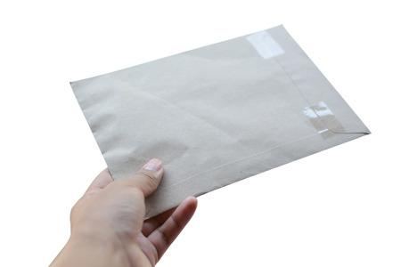 Hand holding paper mail on white backgroundの写真素材
