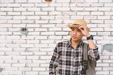 Hipster a man in old wall and relax time on holiday. soft focus color of vintage toneの写真素材