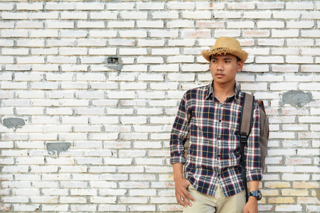 Hipster a man in old wall and relax time on holiday. soft focus color of vintage toneの写真素材