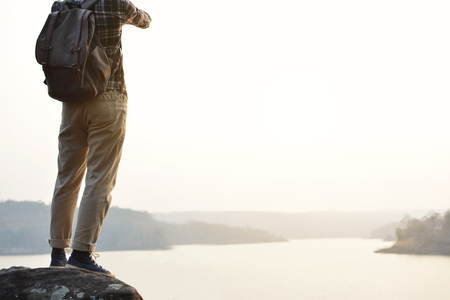 Happy Asian hipster man backpack in nature background, Relax time on holiday concept travel , color of vintage tone and soft focusの写真素材