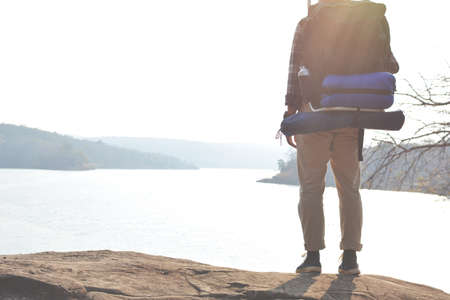 Happy Asian hipster man backpack in nature background, Relax time on holiday concept travel , color of vintage tone and soft focusの写真素材