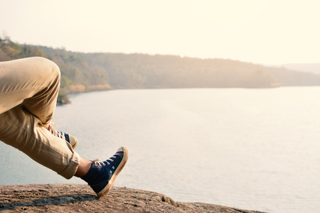 Happy Asian hipster man backpack in nature background, Relax time on holiday concept travel , color of vintage tone and soft focusの写真素材