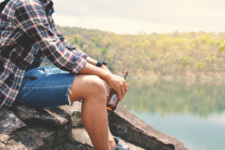 Happy Asian hipster man backpack in nature background, Relax time on holiday concept travel , color of vintage tone and soft focusの写真素材