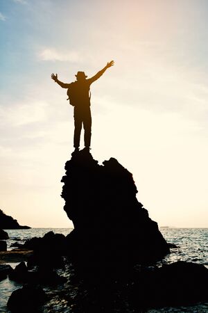 Silhouette of man relaxing on the sea concept travel in summerの写真素材