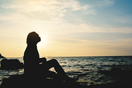 Silhouette of women relaxing on the sea concept travel in summerの写真素材