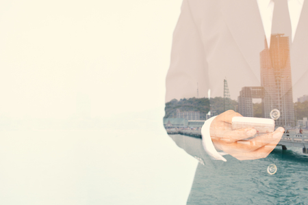 Double exposure businesswomen using smartphone  in building background, selective of focusの写真素材