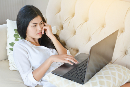Beautiful young women using a computer in the room at home relax time on holidayの写真素材