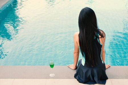 Beautiful  women playing in a pool relax time on holiday. concept summerの写真素材