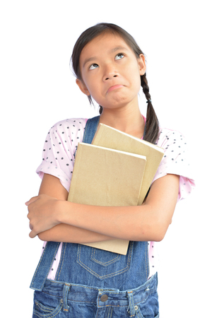 Portrait of little Asian girl holding a book on white backgroundの写真素材