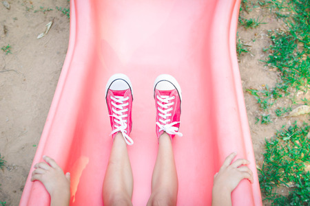 Asian girl playing in playground happy on holiday selective and soft focusの写真素材