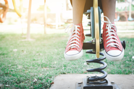 Asian girl playing in playground happy on holiday selective and soft focusの写真素材