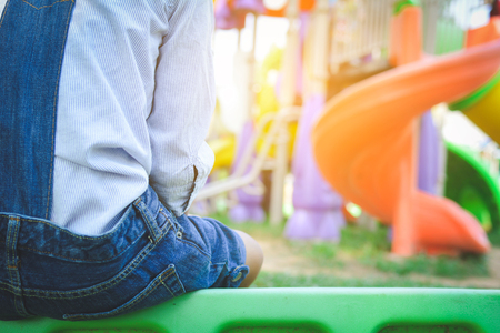 Asian girl playing in playground happy on holiday selective and soft focusの写真素材