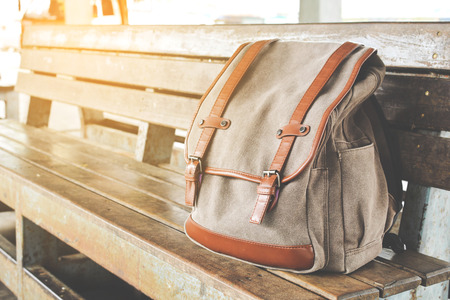 Brown bag on wood chair in bus terminalの写真素材