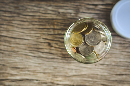 Close up  coin on wood background selective and soft focus hipster toneの写真素材
