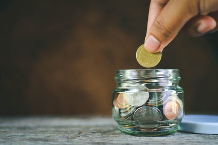 Hands women holding coin selective and soft focus hipster toneの写真素材