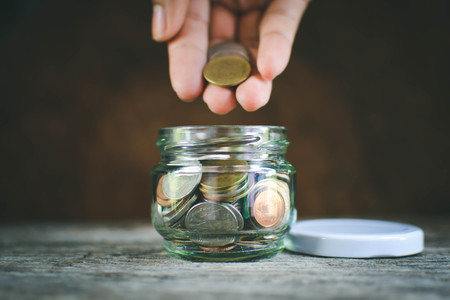 Hands women holding coin selective and soft focus hipster toneの写真素材