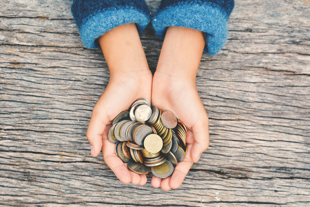 Top view hands girl holding coin selective and soft focus hipster toneの写真素材