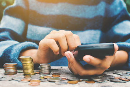 Hands girl holding calculator and coin selective and soft focus hipster toneの写真素材